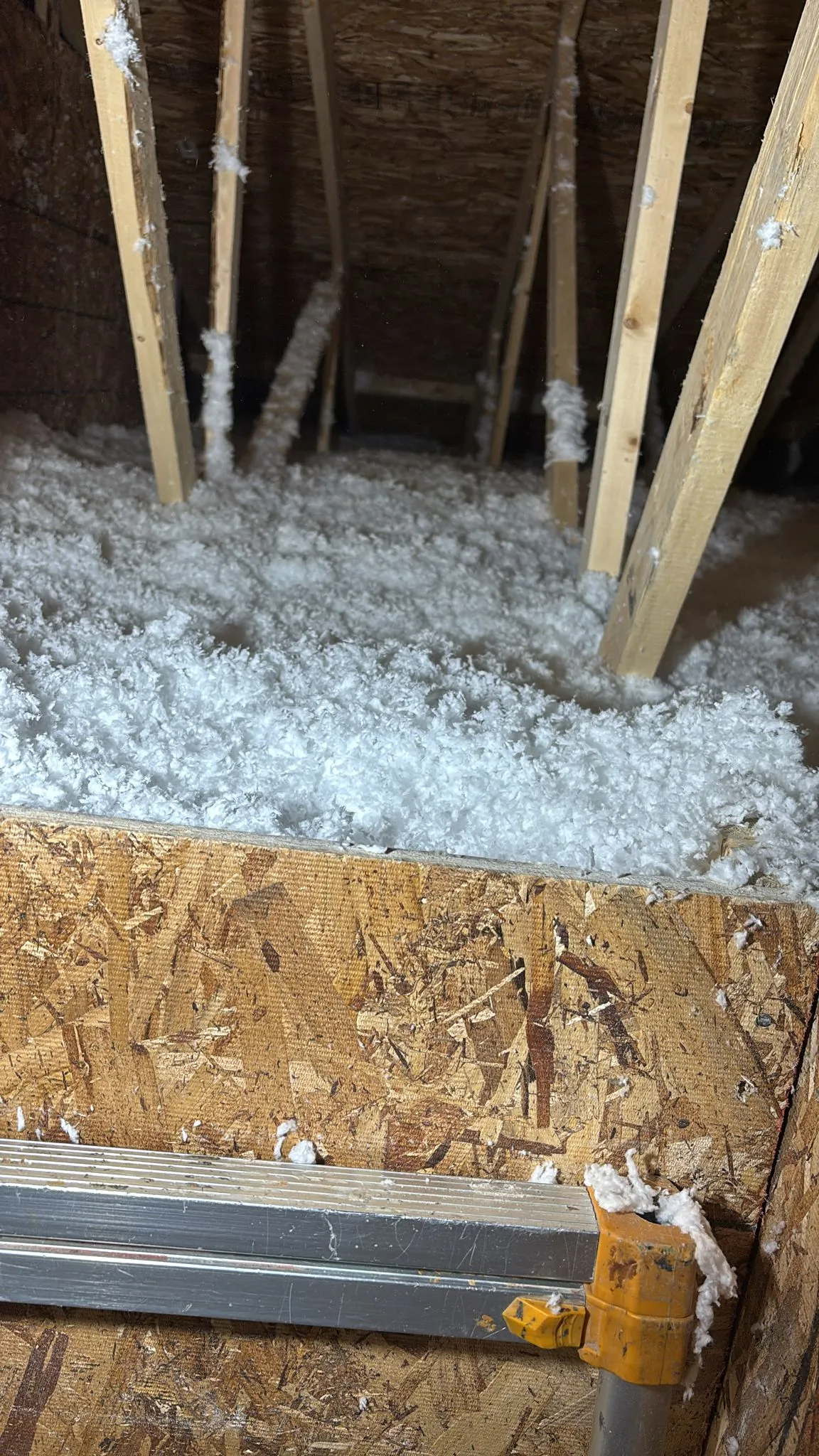Loose-fill blown-in insulation on an attic floor