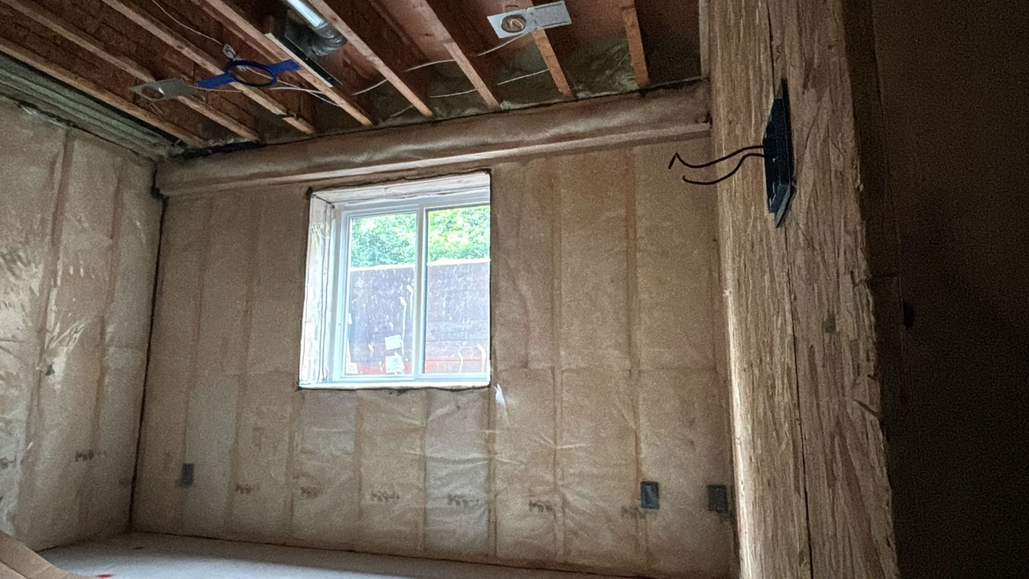 Faced fibreglass batt insulation on basement walls and ceiling