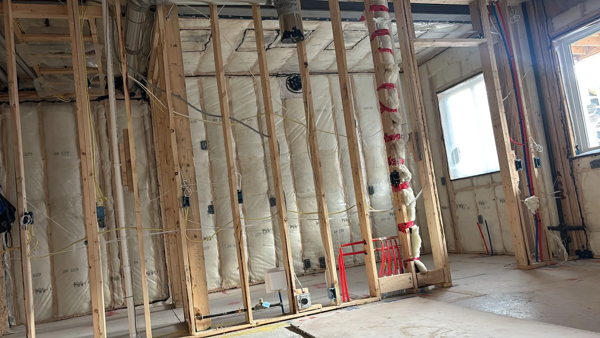 Wide view of insulated framed walls with a vent stack run